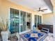 Outdoor patio with comfortable seating, hot tub, and view through sliding doors to the interior at 7527 Sw 97Th Terrace Rd, Ocala, FL 34481
