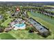 Aerial view of the community featuring a pool, tennis courts, golf course and lake at 8033 Nw 28Th St, Ocala, FL 34482