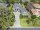 Aerial view of the home featuring a paved driveway and landscaped front yard at 8033 Nw 28Th St, Ocala, FL 34482