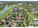 Aerial view of the home near a lake, tennis courts and a golf course at 8033 Nw 28Th St, Ocala, FL 34482