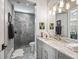 Bathroom with shower, gray cabinets, marble countertop, and modern lighting at 8033 Nw 28Th St, Ocala, FL 34482