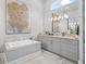 Bathroom featuring a soaking tub, granite counters and contemporary lighting at 8033 Nw 28Th St, Ocala, FL 34482