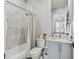 Bathroom with shower/tub, gray cabinets, marble countertop, and modern lighting at 8033 Nw 28Th St, Ocala, FL 34482