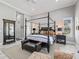 Bright bedroom with a four-poster bed, bench, and serene atmosphere at 8033 Nw 28Th St, Ocala, FL 34482