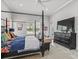Stylish bedroom with a four-poster bed, TV, and comfortable seating area at 8033 Nw 28Th St, Ocala, FL 34482
