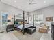 Elegant bedroom with a four-poster bed, neutral color palette, and abundant natural light at 8033 Nw 28Th St, Ocala, FL 34482