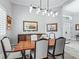 Sunlit dining area featuring a wooden table with seating for six, complemented by sophisticated decor at 8033 Nw 28Th St, Ocala, FL 34482