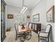 Bright dining room with a wooden table, stylish chairs, and elegant decor creating a welcoming atmosphere at 8033 Nw 28Th St, Ocala, FL 34482