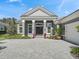 Attractive home with a well-designed driveway, neat landscaping, and double front doors at 8033 Nw 28Th St, Ocala, FL 34482