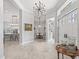 Elegant foyer with tiled floors, a unique chandelier, and a view of the open-concept living spaces at 8033 Nw 28Th St, Ocala, FL 34482