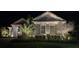Charming home is illuminated by beautiful landscape lighting highlighting manicured landscaping at 8033 Nw 28Th St, Ocala, FL 34482