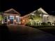 Elegant home with landscape lighting, well-kept yard, and stone-accented columns at 8033 Nw 28Th St, Ocala, FL 34482