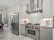 Modern kitchen featuring stainless steel appliances, light gray cabinetry, and white subway tile backsplash at 8033 Nw 28Th St, Ocala, FL 34482