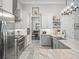 Modern kitchen featuring stainless steel appliances, a spacious island, and white cabinetry at 8033 Nw 28Th St, Ocala, FL 34482