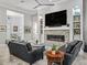 Cozy living room with a stone fireplace, large TV, and comfortable seating arrangement at 8033 Nw 28Th St, Ocala, FL 34482