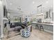 Open concept living room with a stone fireplace, comfortable seating, and a stylish kitchen island at 8033 Nw 28Th St, Ocala, FL 34482
