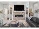 Stylish living room showcasing a stone fireplace, large TV, and decorative shelving at 8033 Nw 28Th St, Ocala, FL 34482