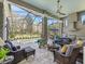 Inviting outdoor living area with a screened pool, stone columns, and a cozy seating arrangement at 8033 Nw 28Th St, Ocala, FL 34482