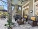 Stylish screened outdoor living space featuring an outdoor kitchen, comfortable seating, and a stone pillar at 8033 Nw 28Th St, Ocala, FL 34482