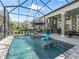 Screened pool with a tanning ledge, fire pit, and an outdoor kitchen area for ultimate outdoor enjoyment at 8033 Nw 28Th St, Ocala, FL 34482