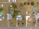 Aerial view of several single Gathering homes on large lots, each with driveways and manicured lawns at 8106 County Road 109, Lady Lake, FL 32159