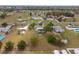 A birds eye view showing homes and lots in a residential neighborhood with varied foliage and swimming pools at 8106 County Road 109, Lady Lake, FL 32159