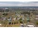 Panoramic aerial view of a community, highlighting houses, landscaping, and a distant water tower at 8106 County Road 109, Lady Lake, FL 32159