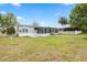 Relaxing backyard view with an enclosed sunroom and white picket fence, offering a private and serene outdoor space at 8106 County Road 109, Lady Lake, FL 32159