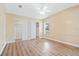 Neutral bedroom with laminate flooring, dual closets, and light-filled window at 8106 County Road 109, Lady Lake, FL 32159