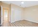 Cozy bedroom featuring laminate floors, a closet, and a doorway leading to the home's bathroom at 8106 County Road 109, Lady Lake, FL 32159