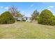 Charming single-story home with a well-manicured lawn, mature landscaping, and a welcoming entrance at 8106 County Road 109, Lady Lake, FL 32159