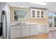 Light and bright kitchen with white cabinets, laminate floors and stainless appliances at 8106 County Road 109, Lady Lake, FL 32159