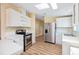 Well-lit kitchen featuring stainless steel appliances, white cabinetry, and bright white countertops at 8106 County Road 109, Lady Lake, FL 32159