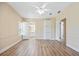 Spacious living room with wood-look flooring, neutral walls, and easy access to other rooms at 8106 County Road 109, Lady Lake, FL 32159