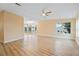 Living room with laminate floors and a chandelier adding a touch of elegance to the space with natural light streaming in at 8106 County Road 109, Lady Lake, FL 32159