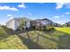 Expansive backyard featuring a screened-in lanai and verdant landscaping around the home at 8802 Sw 79Th Loop, Ocala, FL 34481