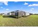 Spacious backyard with a screened-in patio, complemented by lush landscaping and well-maintained lawn at 8802 Sw 79Th Loop, Ocala, FL 34481