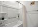 Bathroom with a white tub, shower, and decorative nautical decor at 8802 Sw 79Th Loop, Ocala, FL 34481