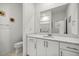 Well-lit bathroom featuring a large mirror, white cabinets, and a toilet at 8802 Sw 79Th Loop, Ocala, FL 34481