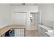 Bright bedroom with a large closet, desk, and view into the kitchen at 8802 Sw 79Th Loop, Ocala, FL 34481