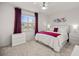 A well-lit bedroom features a comfortable queen-sized bed, coordinated linens, and bright natural light from the window at 8802 Sw 79Th Loop, Ocala, FL 34481