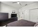 The dark bedroom has a large closet, coordinated dresser, and a door to another room at 8802 Sw 79Th Loop, Ocala, FL 34481