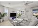 Bright living room with a large sectional sofa, modern fireplace, and large windows for natural light at 8802 Sw 79Th Loop, Ocala, FL 34481