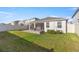 A spacious backyard with green grass, a stone fire pit, and a screened lanai, perfect for outdoor entertaining at 8899 Sw 50Th Ave, Ocala, FL 34476