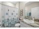 Bathroom with granite countertops, decorative shower curtain and tile flooring at 8899 Sw 50Th Ave, Ocala, FL 34476