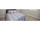 Bright bedroom featuring a comfortable bed with stylish bedding, a carpeted floor, and a window for natural light at 8899 Sw 50Th Ave, Ocala, FL 34476