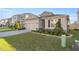 Attractive home with a two-car garage, stone accents, and lush landscaping at 8899 Sw 50Th Ave, Ocala, FL 34476
