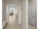 Bright and airy hallway with neutral tones and tile flooring leading to the living area at 8899 Sw 50Th Ave, Ocala, FL 34476