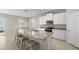 Bright kitchen features an island with a granite countertop and seating at 8899 Sw 50Th Ave, Ocala, FL 34476