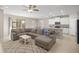 Open-concept living room featuring a cozy sectional, modern kitchen, and ample natural light at 8899 Sw 50Th Ave, Ocala, FL 34476